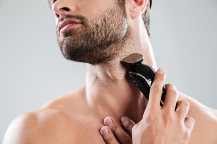 bearded-man-using-electric-razor